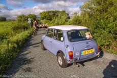 Ireland - Classic Car Road Trip Ireland:&nbsp;A shepherd with a herd of sheep walking in front of the Mini Authi on the road near Westport, a picturesque...