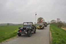 Operation Quick Anger Commemoration 2018 - Operation Quick Anger Commemoration and Memorial Tour 2018: A convoy of WWII military vehicles driving on the narrow dyke road between...