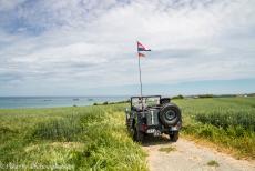 75th anniversary of D-Day - Classic Car Road Trip Normandy, 75 years after D-Day: Our own Jeep on a plateau overlooking Gold Beach at Arromanches-les-Bains, the remains...