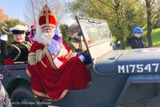 Arrival of Sinterklaas - Arrival of Sinterklaas in a 1942 Ford GPW Jeep, November 2022: Sinterklaas is dressed in a long red velvet tabard (cape) over a...