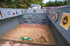 Normandy 2014 - Classic Car Road Trip Normandy: Remembrance crosses with poppies, placed inside an Allied landing craft, the memorials to those...