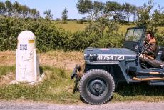 Normandy, 65 years after D-Day - Classic Car Road Trip Normandy 2009: Our RAF blue Ford Jeep next to a milestone along the Liberty Road (French: La Voie de la...